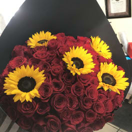 Bouquet of red roses with yellow sunflowers in black wrap