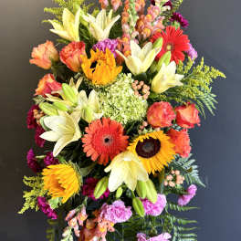 Tall mixed flower spray with lilies, gerberas, roses, and snapdragons