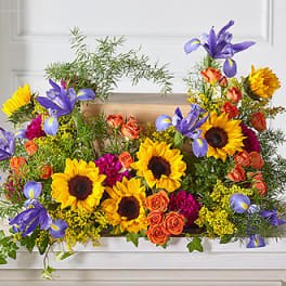 Bright mixed bouquet with sunflowers, purple irises, and orange roses