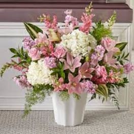 Pink and white floral arrangement in a white vase