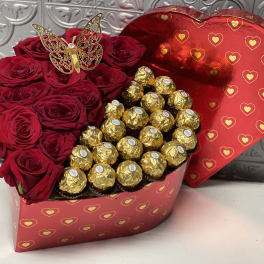 Heart-shaped box with red roses and gold-wrapped chocolates