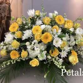 Yellow roses and white daisies arranged in a large bouquet