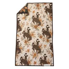 Patterned quilted throw with cowboy silhouettes and autumn flowers