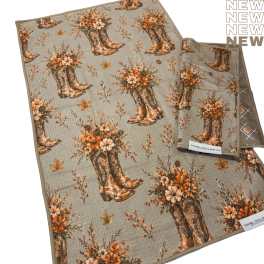 Folded towels with a cowboy boots and autumn flowers print