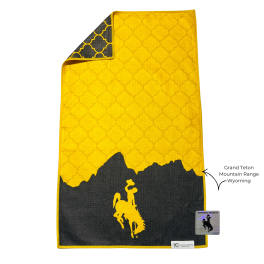 Yellow and black towel with a mountain silhouette and cowboy graphic