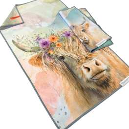 Folded towels with a cow print and floral accents