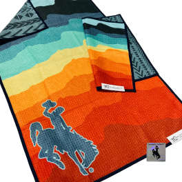 Colorful striped towel with a horse rider logo