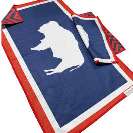 Blue and red towel with a white animal silhouette and folded corner