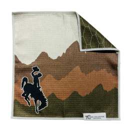 Folded towel with a cowboy rider silhouette and mountain pattern