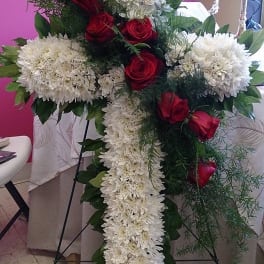 Cross-shaped floral spray with white chrysanthemums and red roses