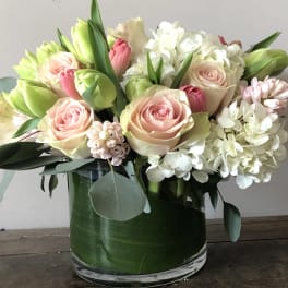 Pink roses and white hydrangeas in a glass vase