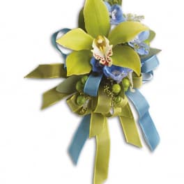 Boutonniere with green orchid petals and blue ribbon accents