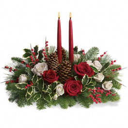 Holiday centerpiece with red candles, roses, pinecones, and evergreen