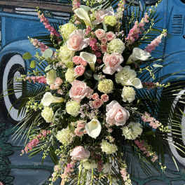Tall floral spray with pale pink roses, white calla lilies, and pink accents