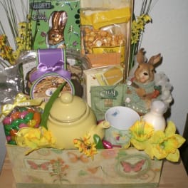 Gift basket with candy, tea, a teapot, and a bunny figurine
