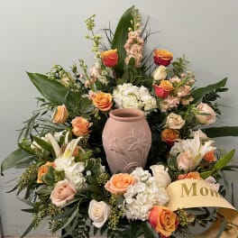 Large floral arrangement with roses, lilies, and a pink vase centerpiece