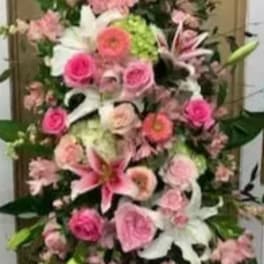 Tall pink and white floral arrangement with lilies and roses