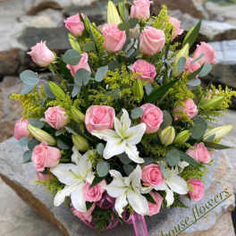 Pink roses and white lilies arranged in a bouquet
