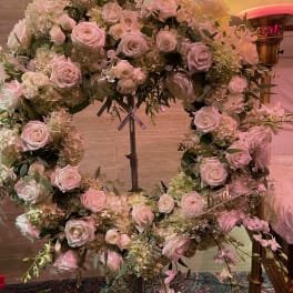 Heart-shaped floral wreath of pale pink and white roses