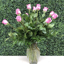 Pink roses arranged in a clear glass vase