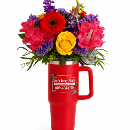 Bright mixed bouquet in a red handled tumbler with a clear lid