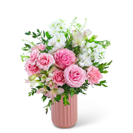 Pink roses and white flowers arranged in a pink vase