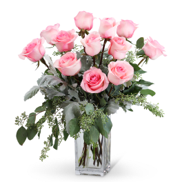 Pink roses arranged in a clear glass vase