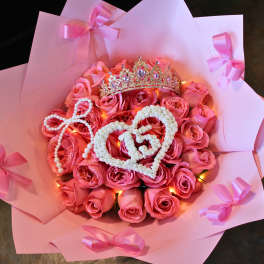Pink rose bouquet with a jeweled crown and heart decorations