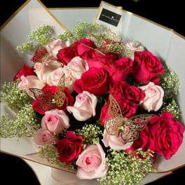 Bouquet of red and pale pink roses with butterfly picks