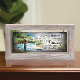 Framed memorial plaque with a fisherman scene and sympathy text