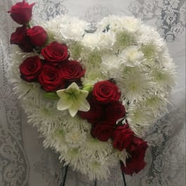 Heart-shaped bouquet of red roses and white chrysanthemums