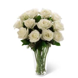 White rose bouquet in a clear glass vase