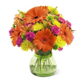 Orange and pink mixed bouquet in a green glass vase