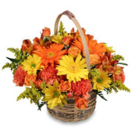 Basket of orange and yellow flowers with a handle