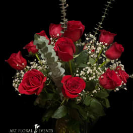 Bouquet of red roses with baby's breath and eucalyptus in a vase
