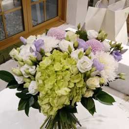 Bouquet of green hydrangea, white roses, and lavender flowers
