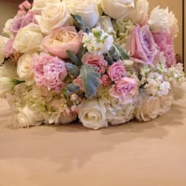 Bouquet of white and blush roses with pale hydrangeas