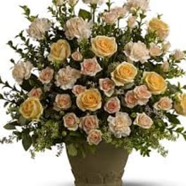 Arrangement of pale yellow and blush roses in a vase
