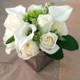 White roses and calla lilies in a square vase
