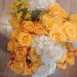 Bouquet of yellow roses with white hydrangeas and yellow filler flowers