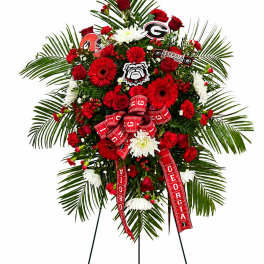 Red and white floral standing spray with Georgia Bulldogs ribbons and logos