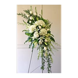Tall white floral standing spray on an easel