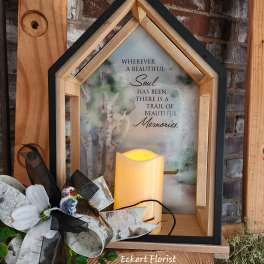 Wooden memorial lantern with a candle and floral bow