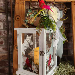 White lantern with red bird decoration and ribbon accents