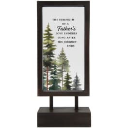 Framed memorial sign with trees and a father tribute message