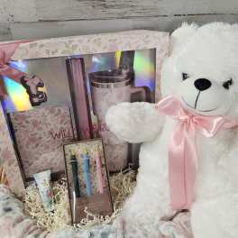 Gift basket with a teddy bear, boxed tumbler set, and pens