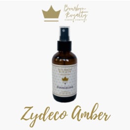 Amber spray bottle labeled Bourbon Royalty and Zydeco Amber