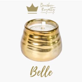 Gold candle in a rounded metallic holder with a white wick