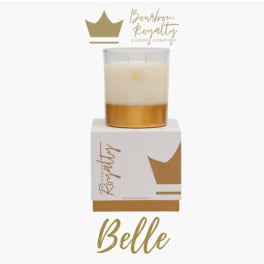Gold and white candle in a glass jar on a branded box