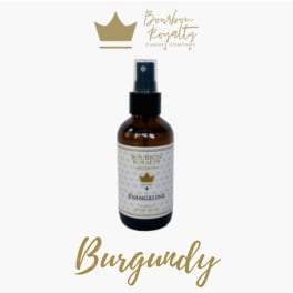 Amber spray bottle labeled Bourbon Royalty with a crown logo